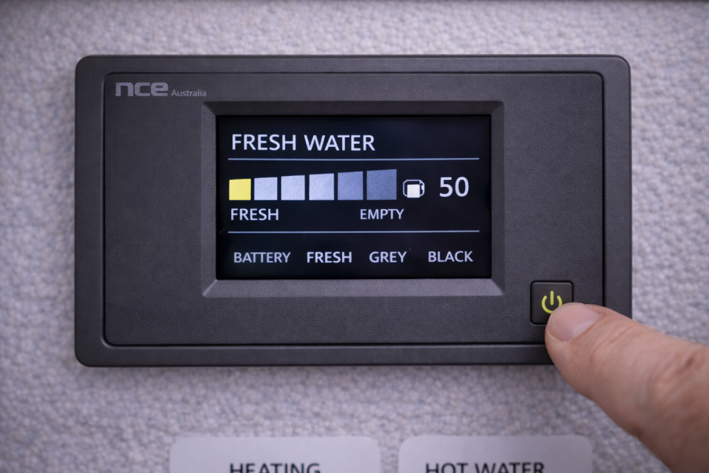 Checking caravan fresh water tank level before priming pump