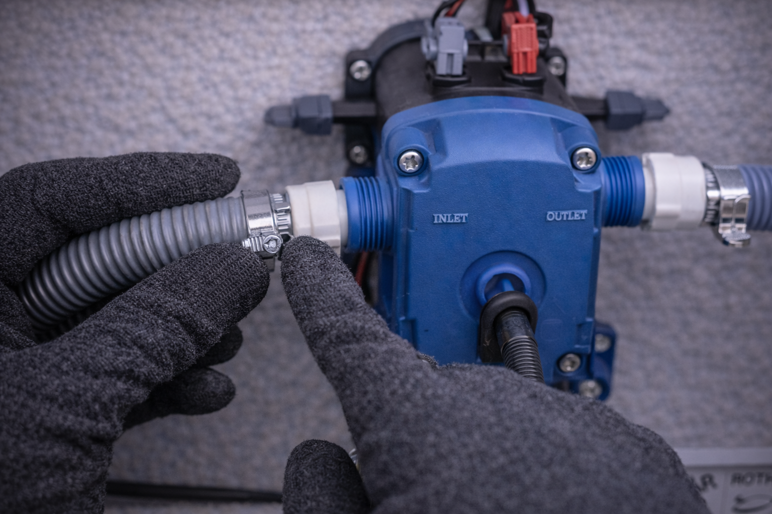 Checking water pump hose connections for air leaks 