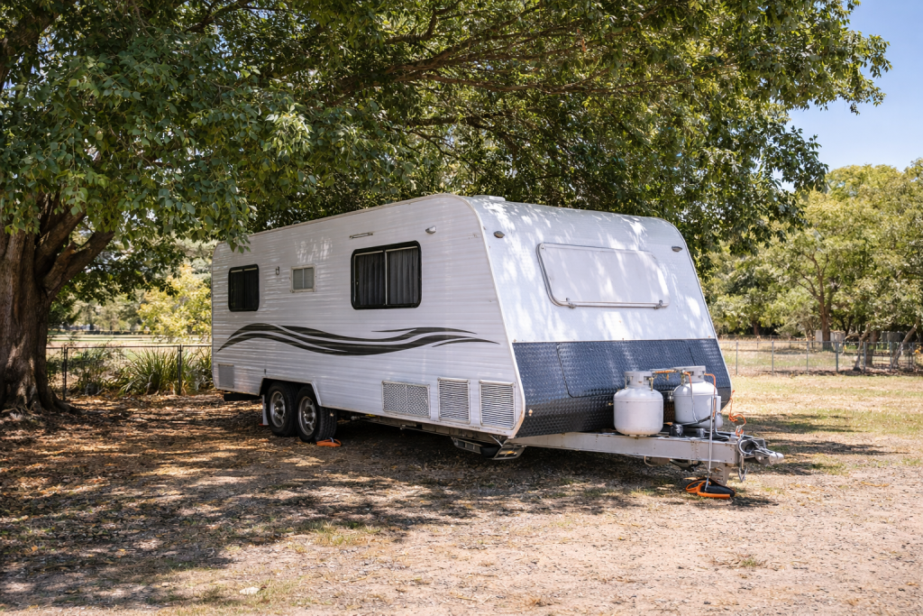 Caravan stored under shade during summer 
