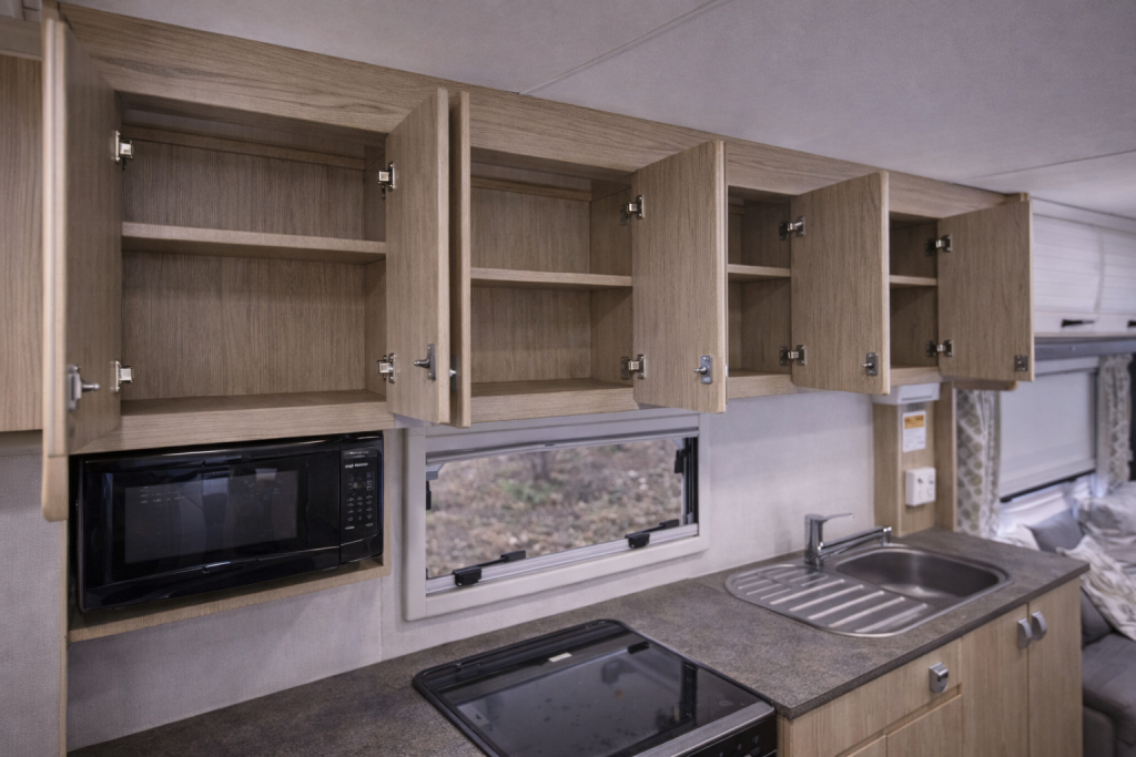 Empty caravan cupboards before reinforcing storage