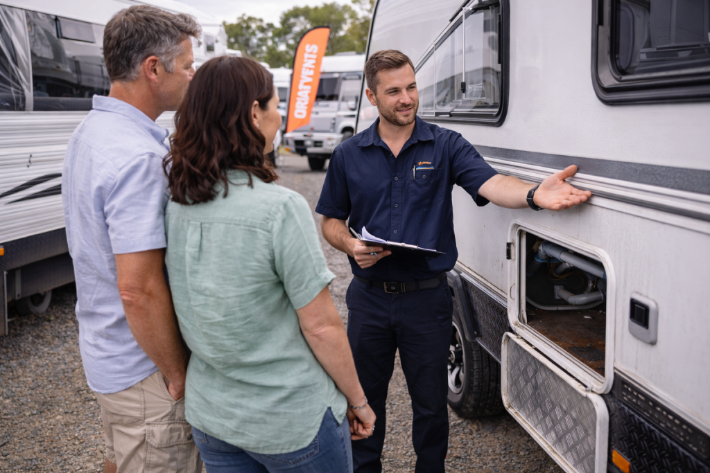 Buyer inspecting a caravan with salesperson present