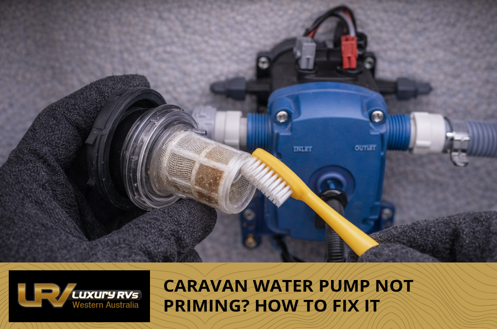 Person checking freshwater tank level gauge on a caravan before priming the water pump.